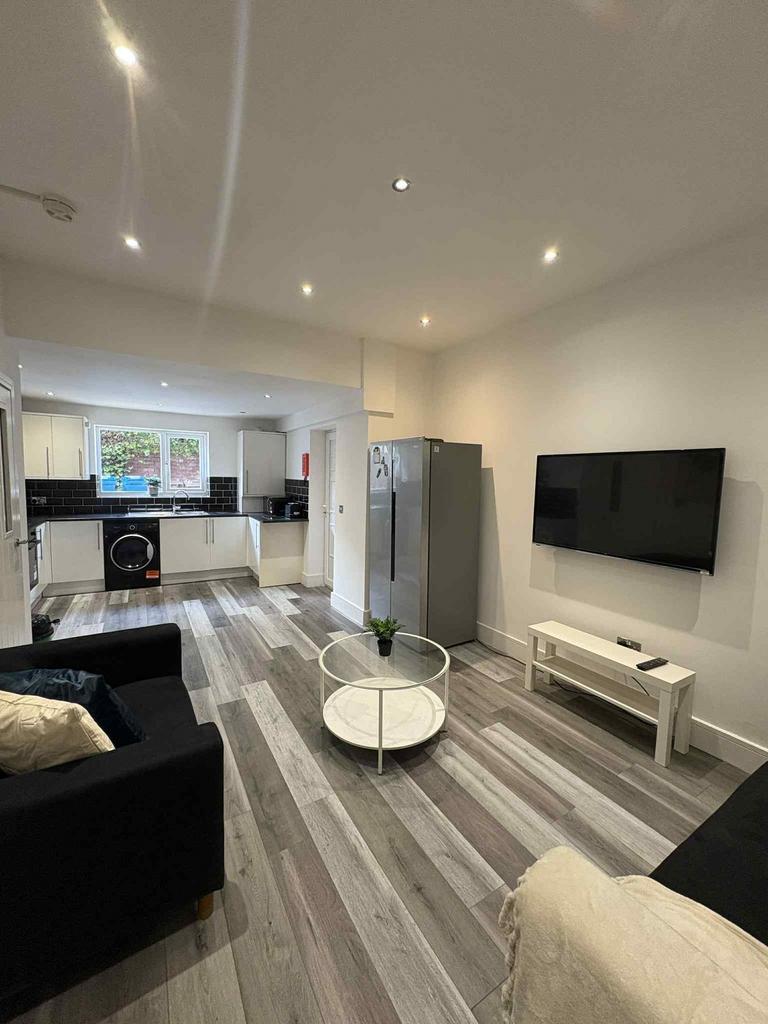 Bright and modern living room featuring a large...