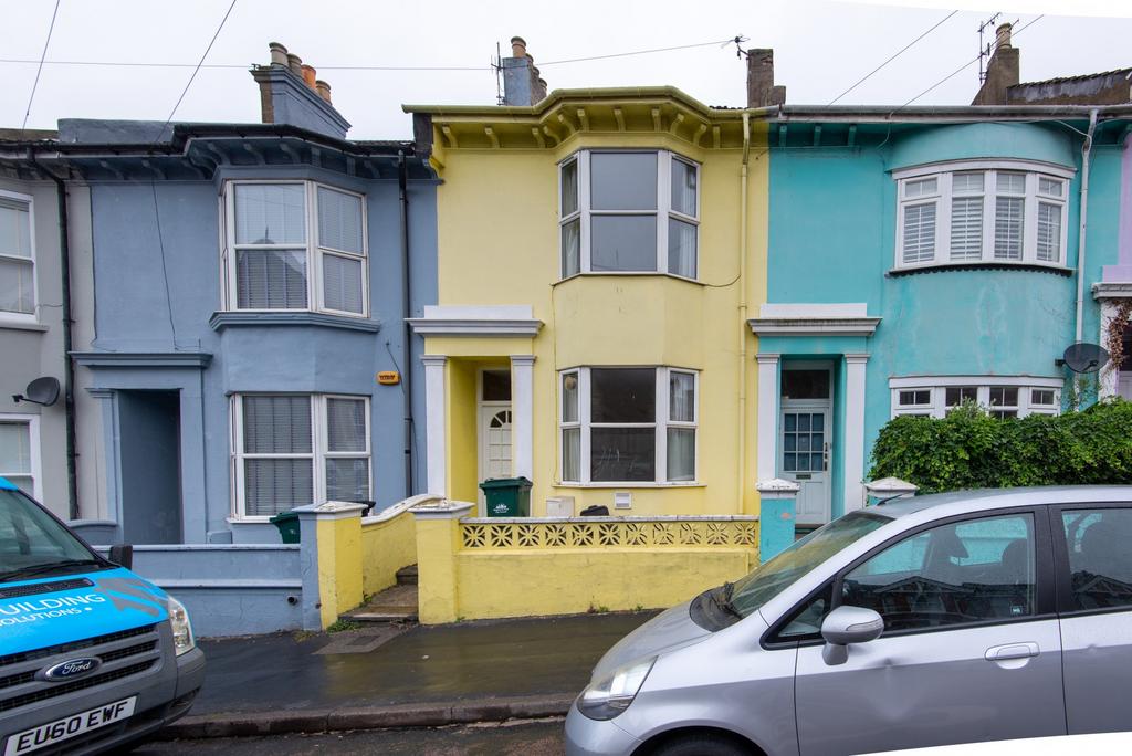 A charming front view of a vibrant terraced hou...