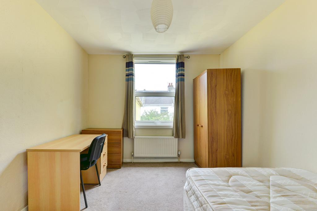Bright, simply furnished single bedroom with a ...