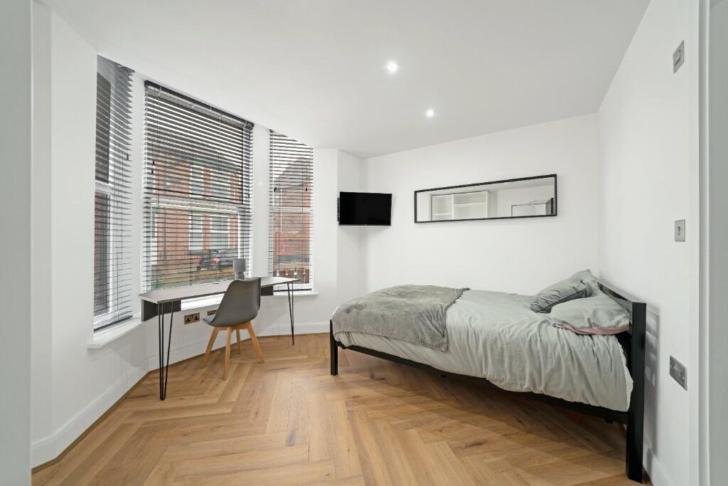 A bright and spacious living room with large wi...