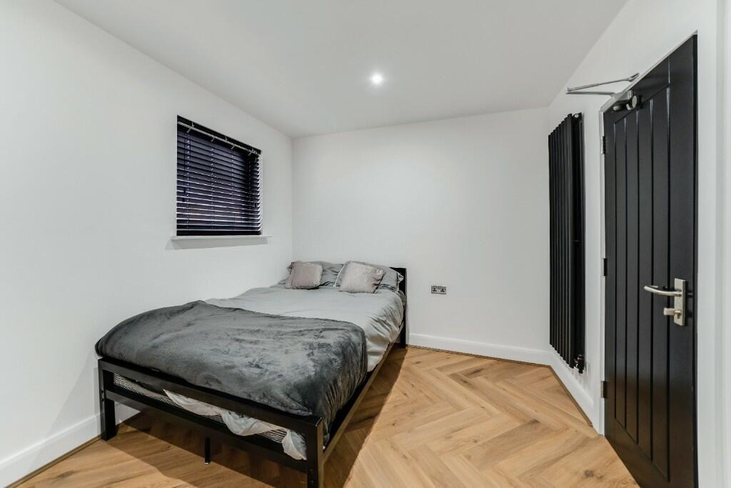 A neatly presented single bedroom with a comfor...