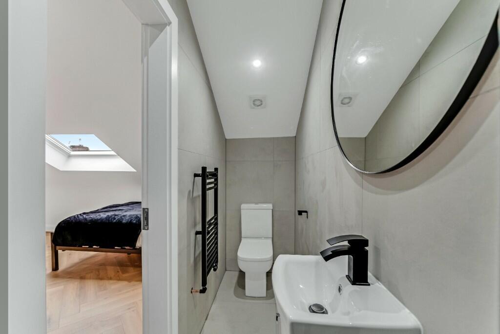 Modern and clean bathroom with a large mirror, ...