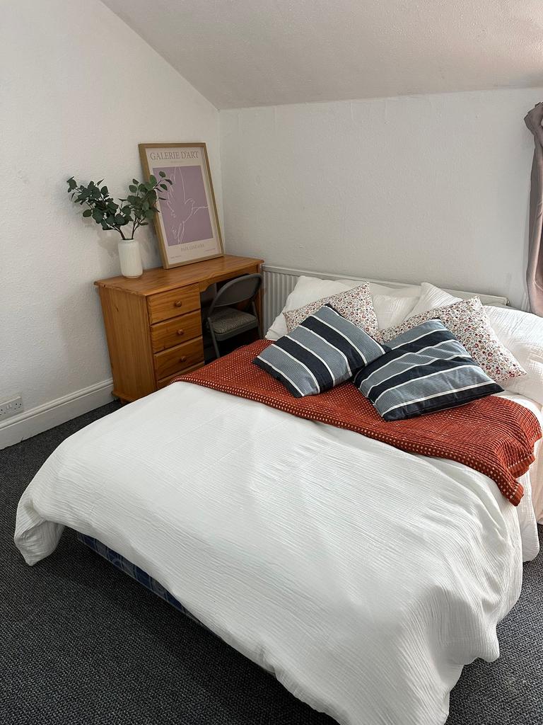 A well-presented bedroom featuring a comfortabl...