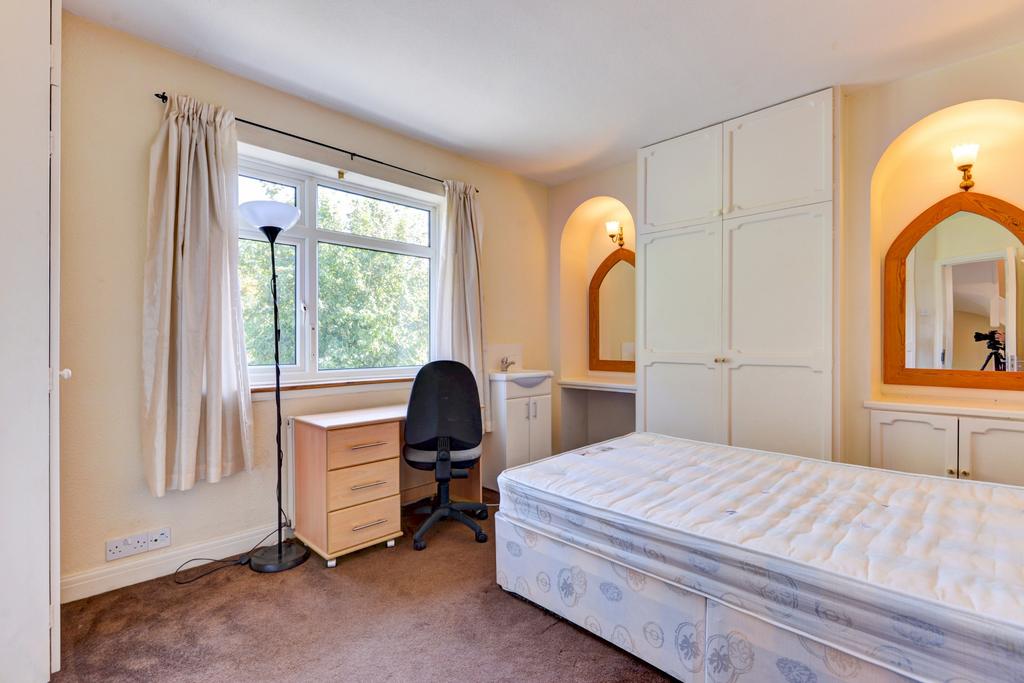 Bright, neatly presented bedroom with a large w...