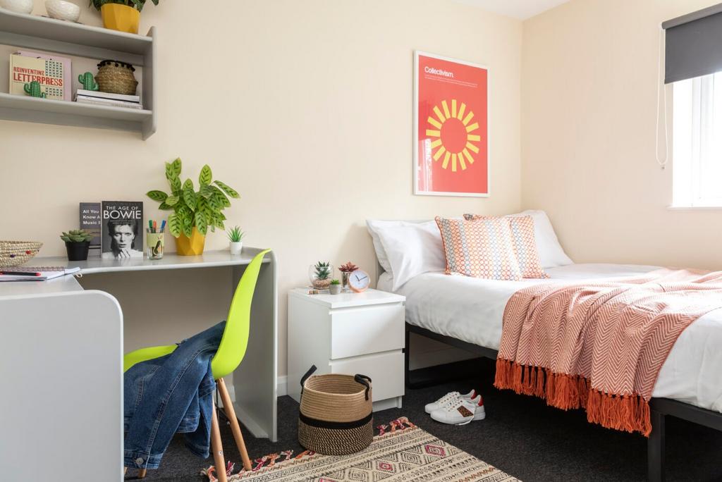 A bright and stylish bedroom featuring a cozy b...
