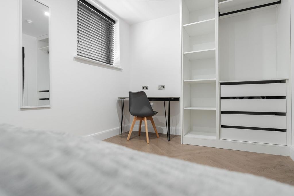 A modern, well-maintained bedroom featuring a s...