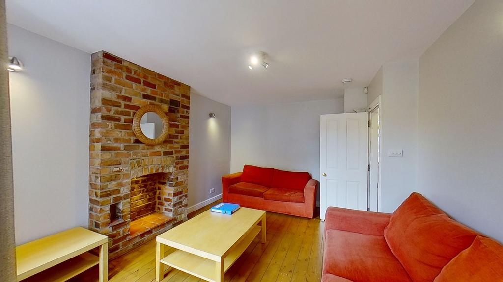 Bright, modern living room with exposed brick f...