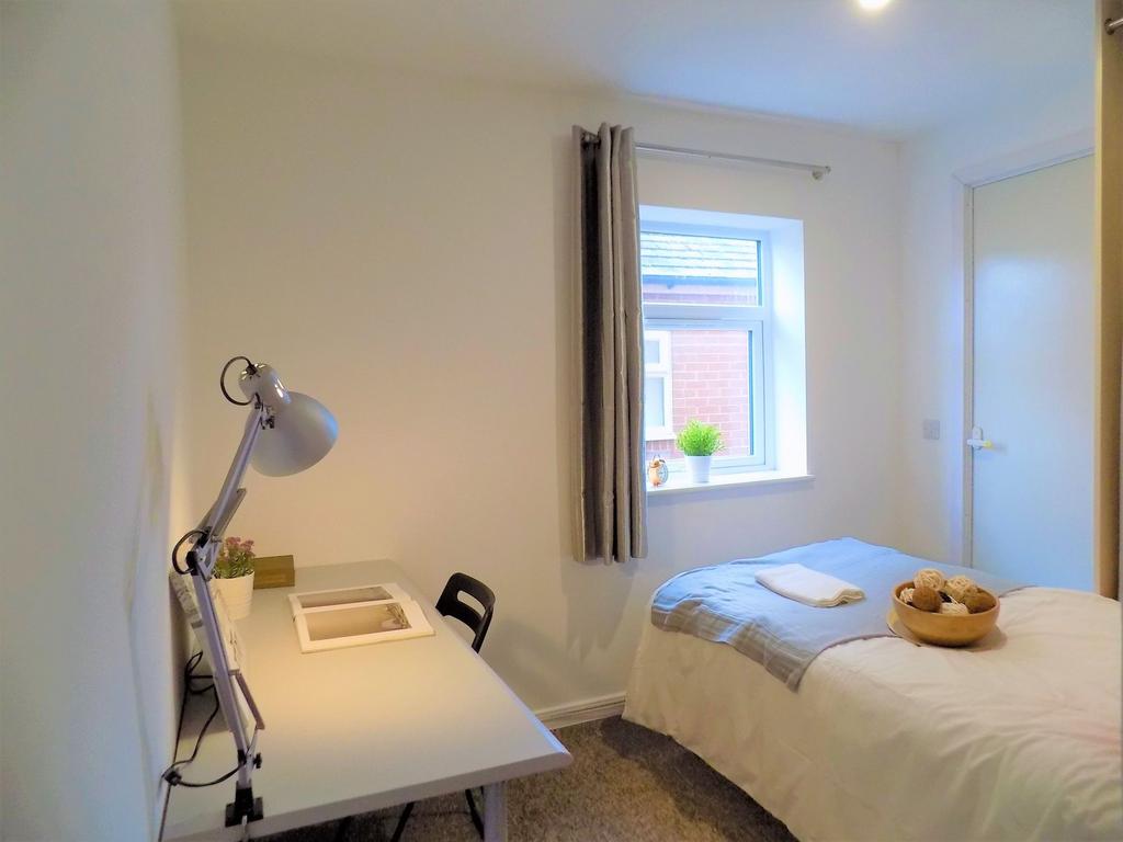 Bright and tidy single bedroom featuring a cozy...