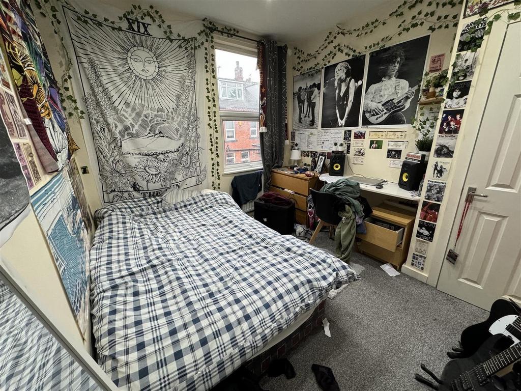 A cozy student bedroom featuring a double bed w...