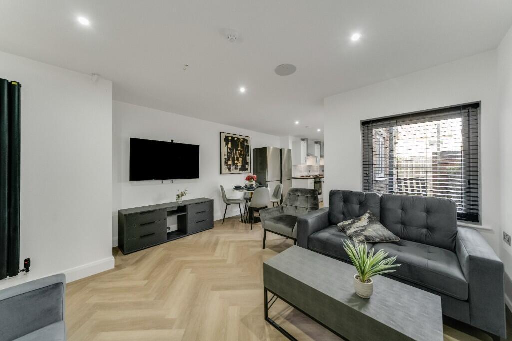 A spacious and contemporary living room with mo...