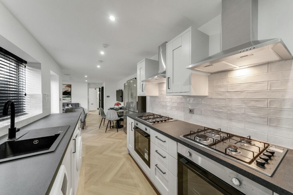 Modern galley-style kitchen with integrated app...