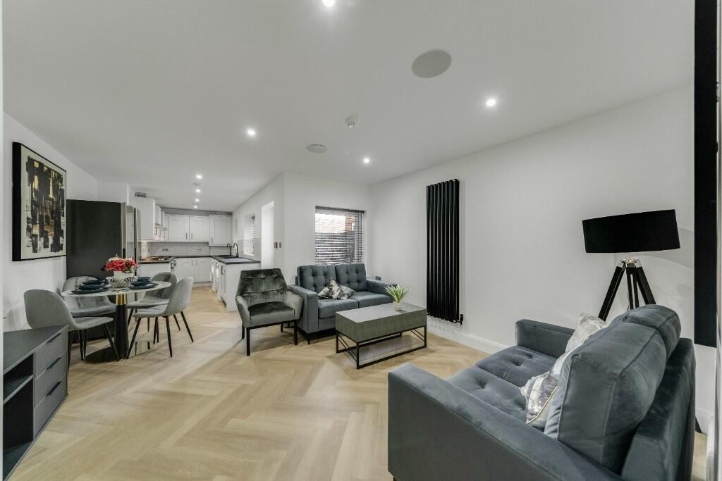 A spacious and modern living room featuring sty...