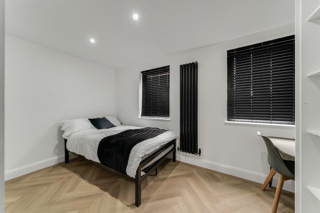 A bright and tidy double bedroom featuring a co...