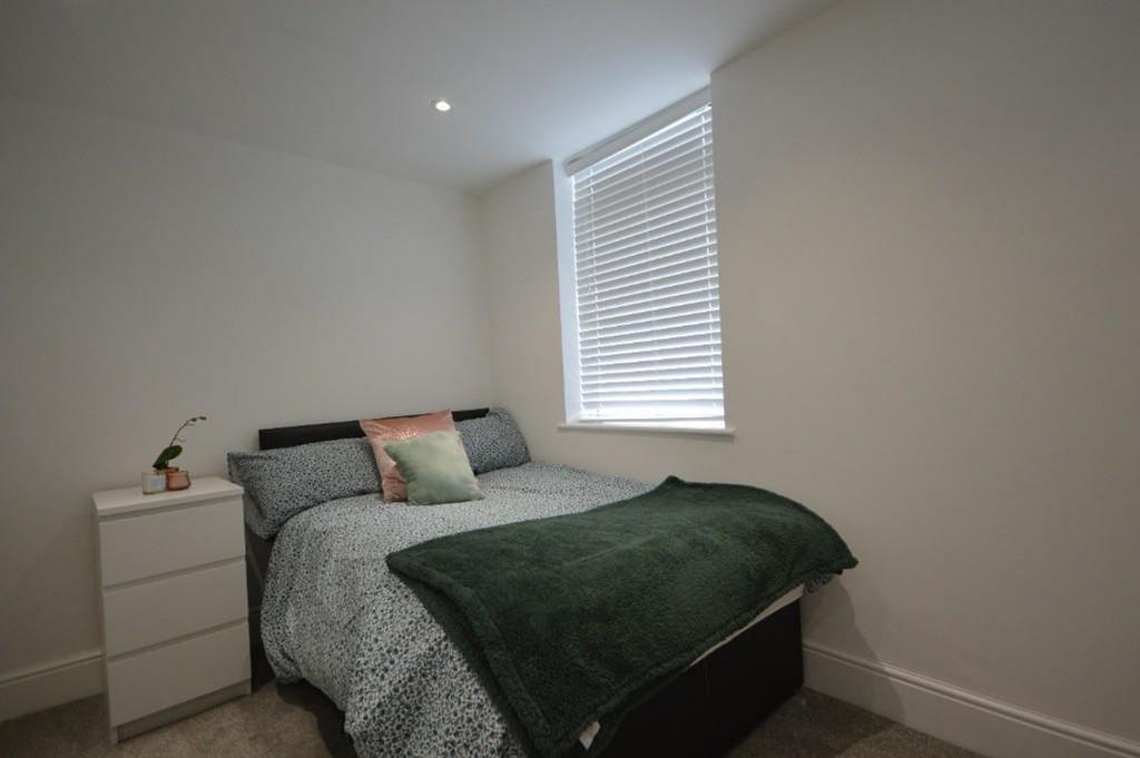 Cozy and inviting double bedroom featuring a co...