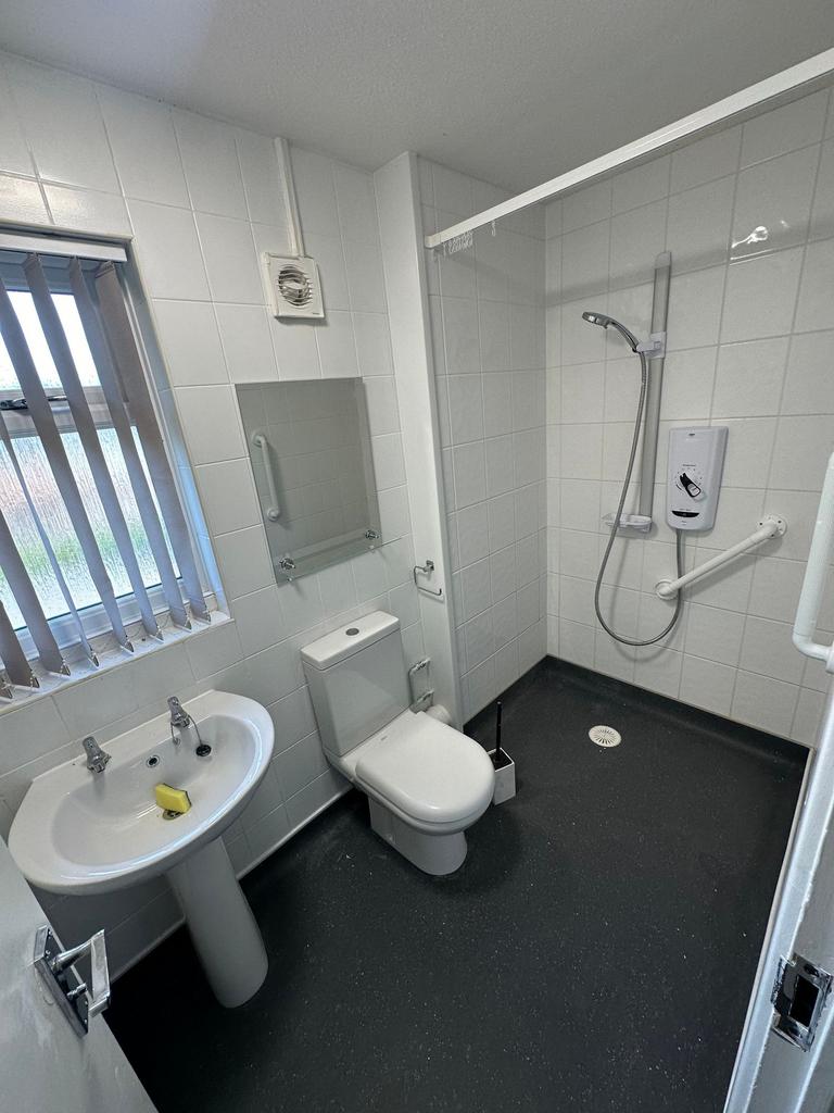 Bright and clean bathroom with a walk-in shower...