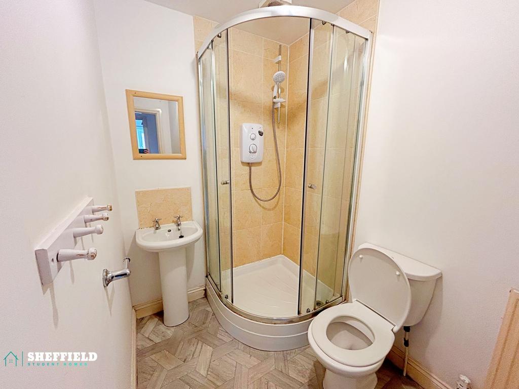 Clean and compact bathroom with a corner glass-...