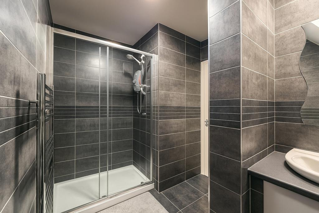 Modern tiled bathroom with a large walk-in show...