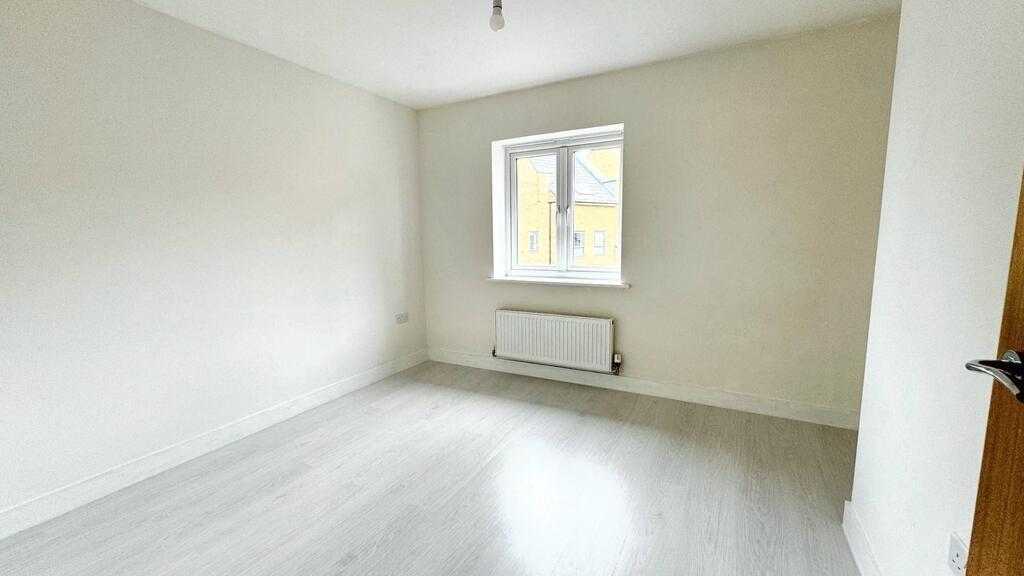 Bright, freshly painted bedroom with neutral wa...
