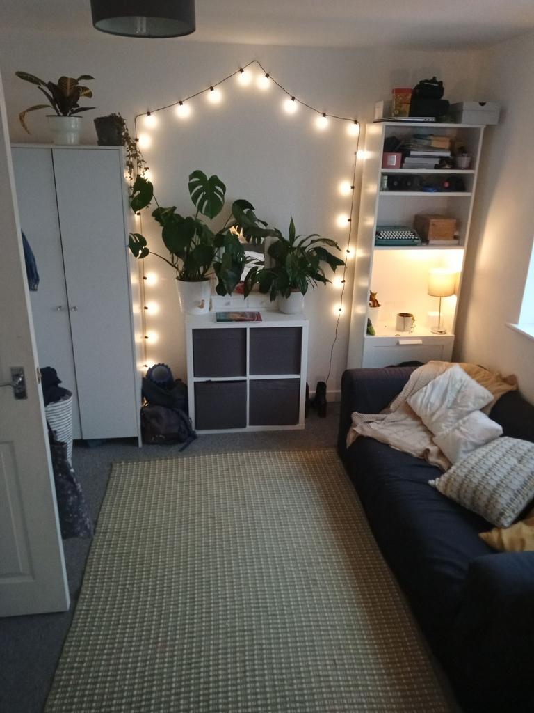Cosy living room with a comfortable dark sofa, ...
