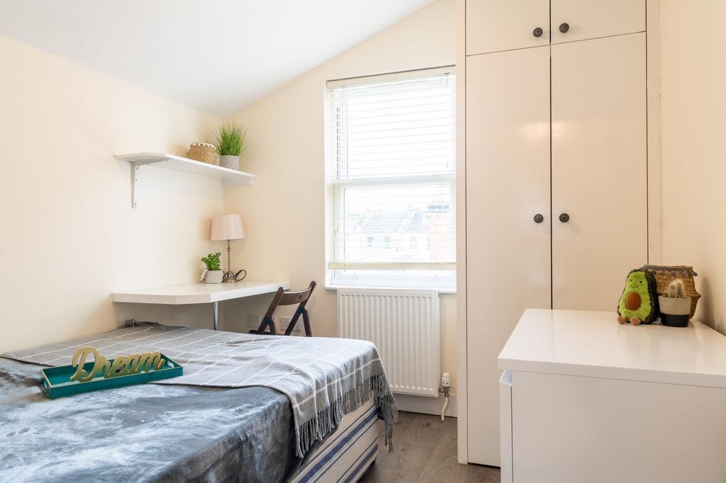 Bright, neatly styled bedroom with a cosy bed, ...