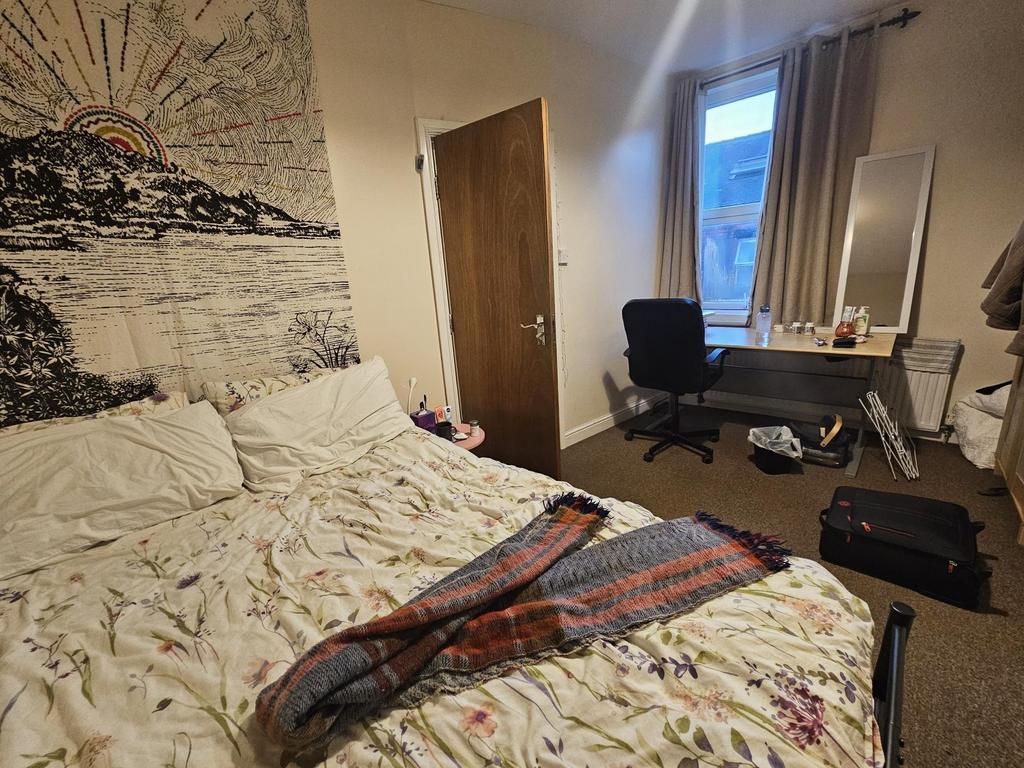 Cozy double bedroom with a comfortable bed, ful...
