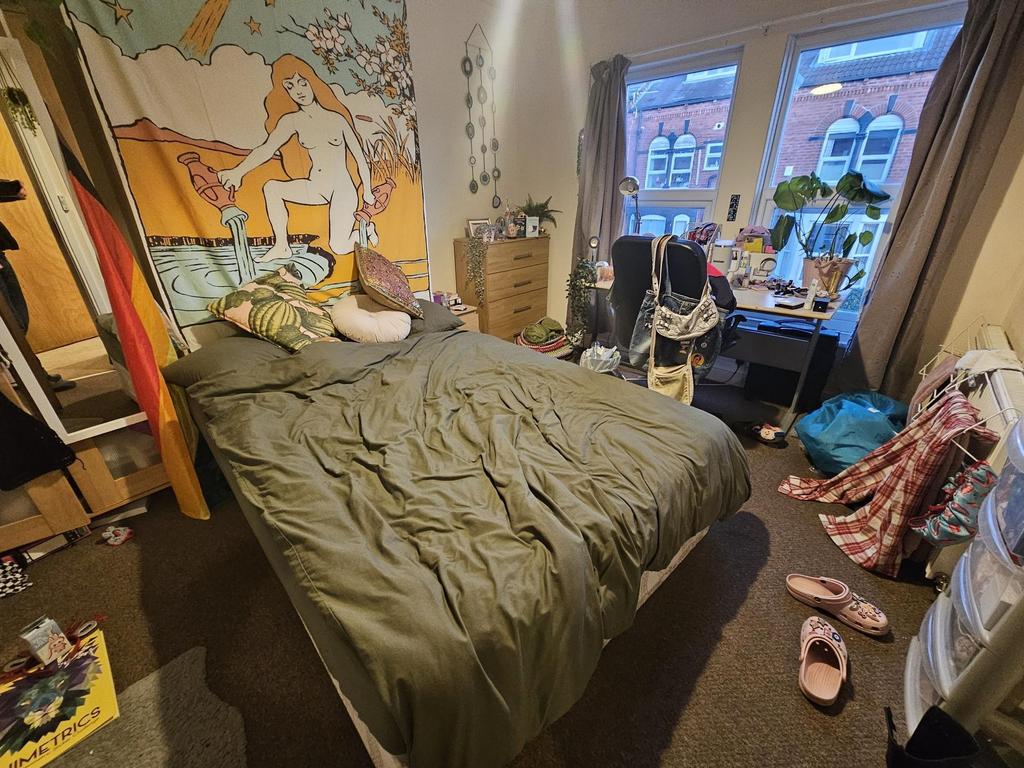 Cosy double bedroom with a large bed, colourful...