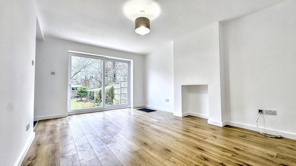 Bright, modern living room with oak-style floor...