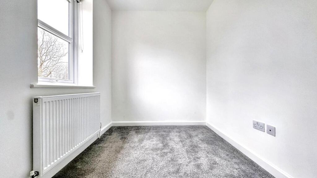 Bright, freshly painted single bedroom with a l...