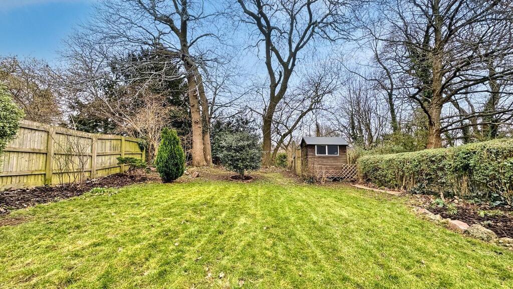 Well-maintained rear garden with a wide flat la...