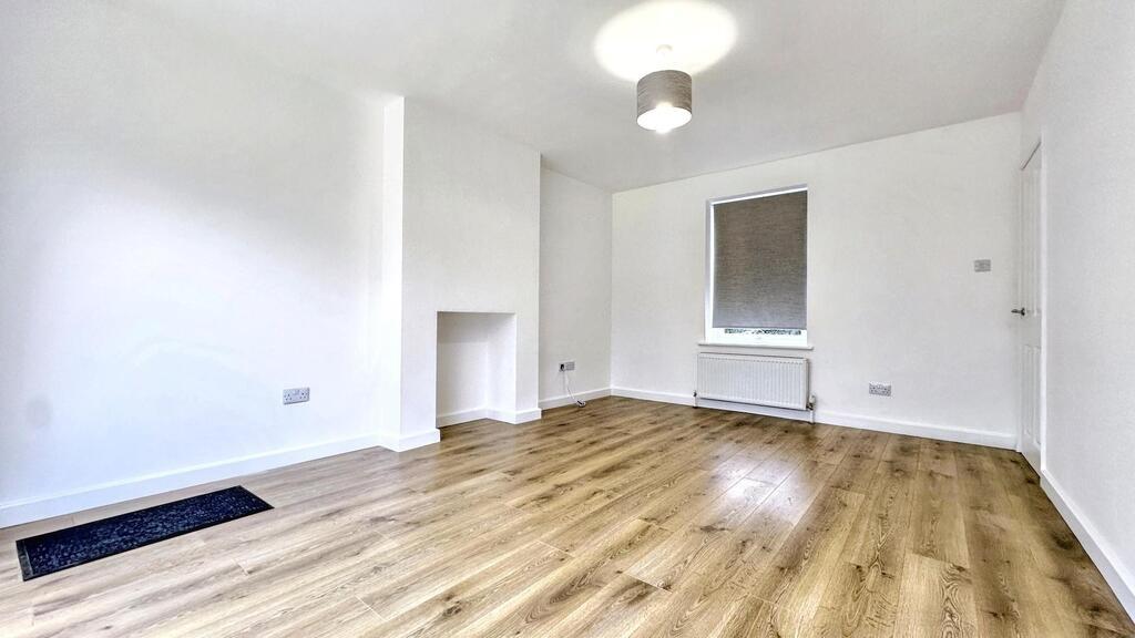 Bright, freshly redecorated living room with cl...