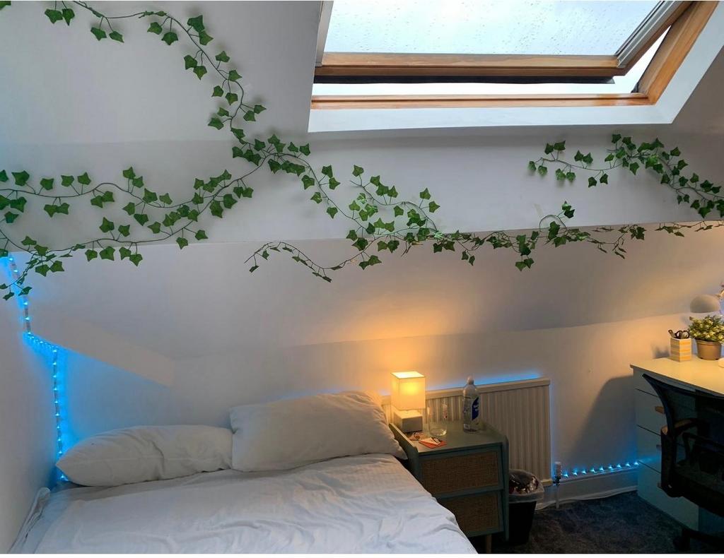 A cozy and well-maintained bedroom with a large...