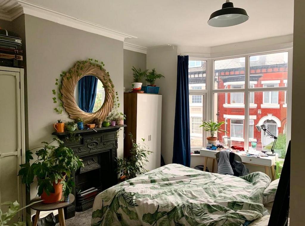 A bright, nicely maintained bedroom featuring a...