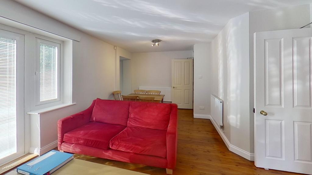 Bright, neutral living room with wooden floors,...