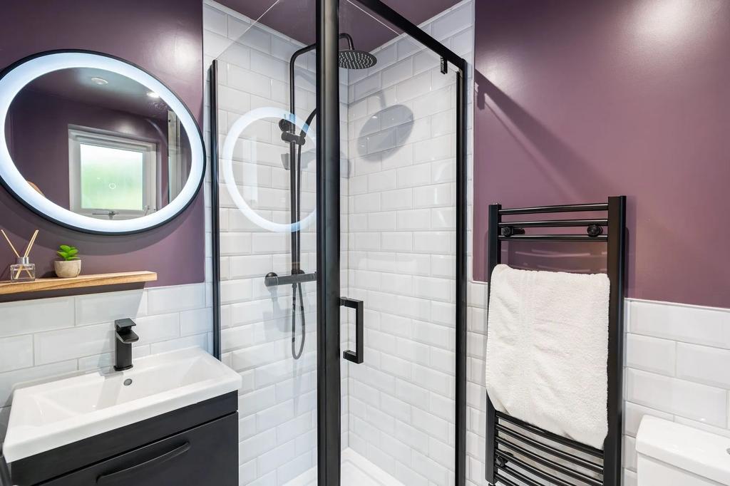 Modern bathroom featuring a sleek walk-in showe...