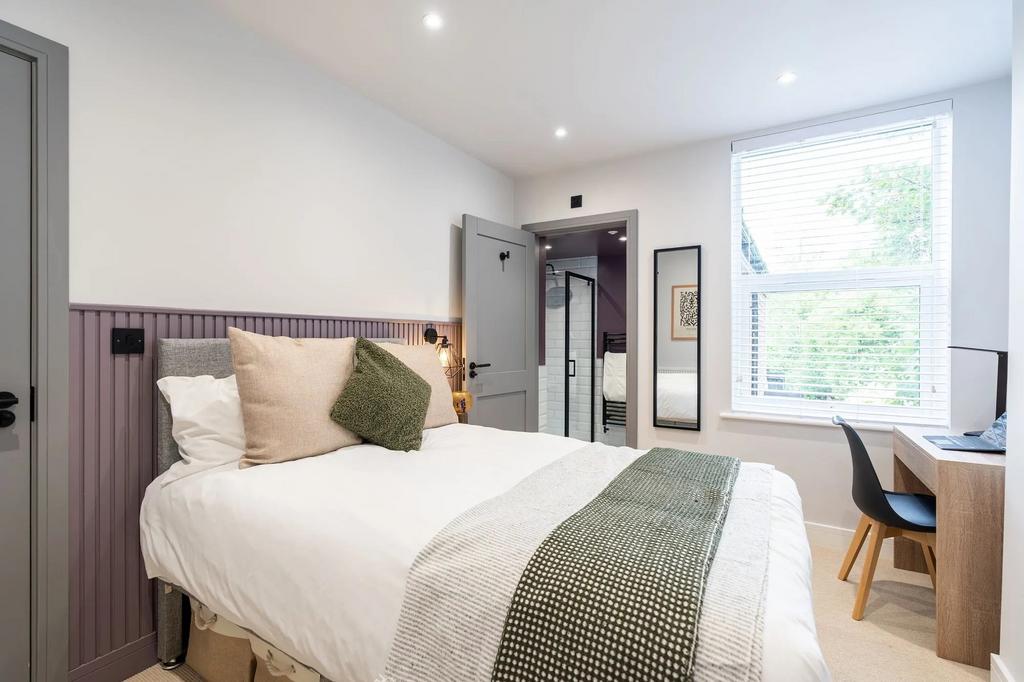 Bright and inviting bedroom featuring a comfort...