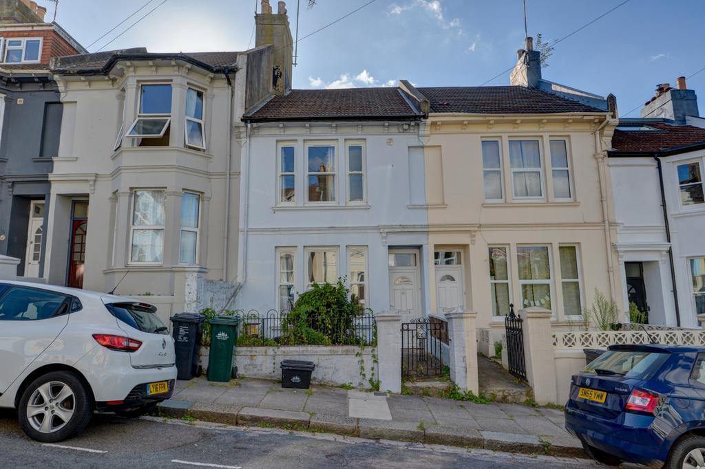 A charming front exterior of a terraced house w...