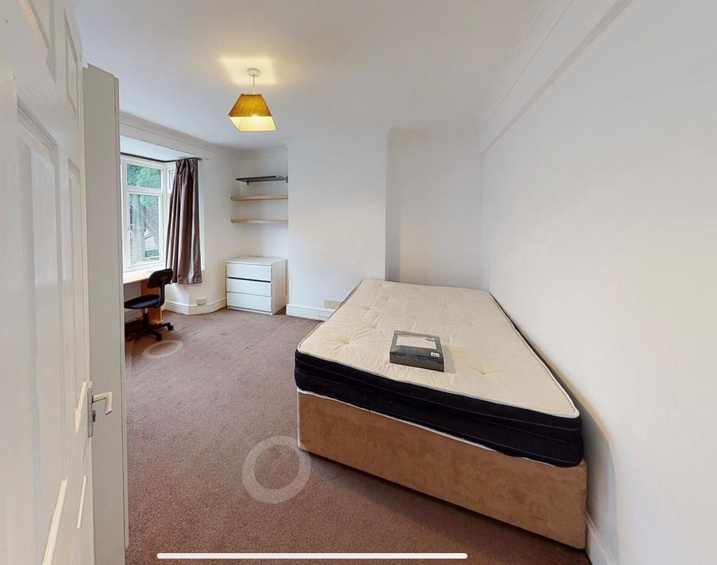 Bright, simply furnished single bedroom with a ...