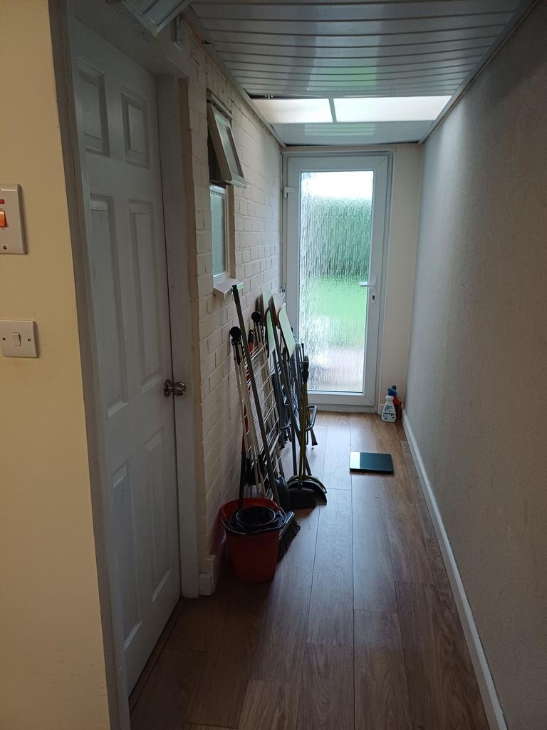 Long narrow hallway with wood-effect flooring, ...