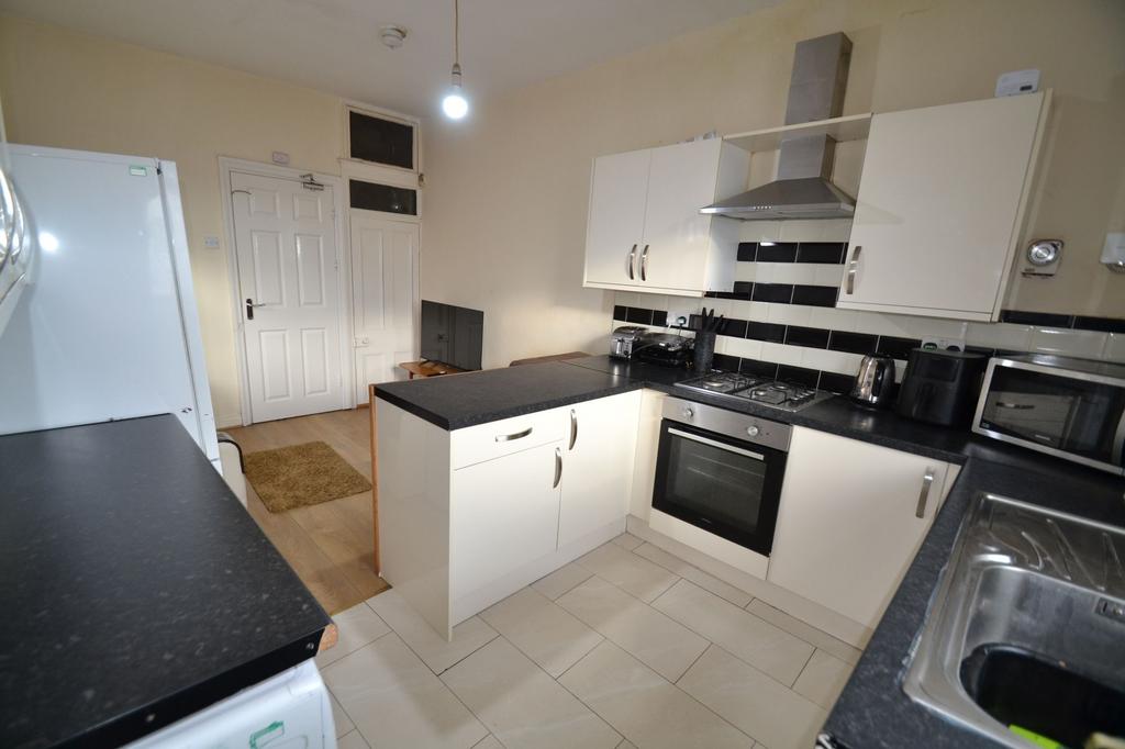 Modern fitted kitchen with gloss white cabinets...