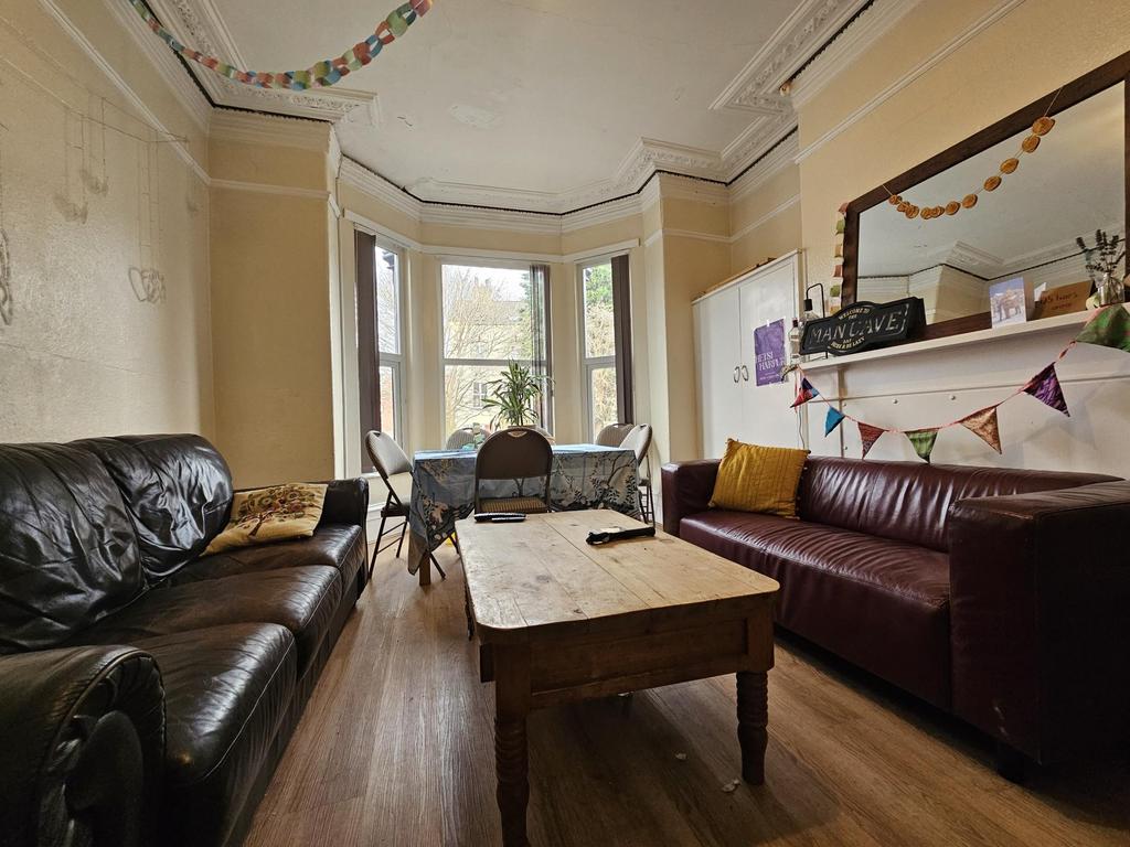 Comfortable communal lounge with bay window sea...