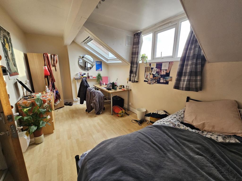 Cozy attic double bedroom with sloped ceilings,...
