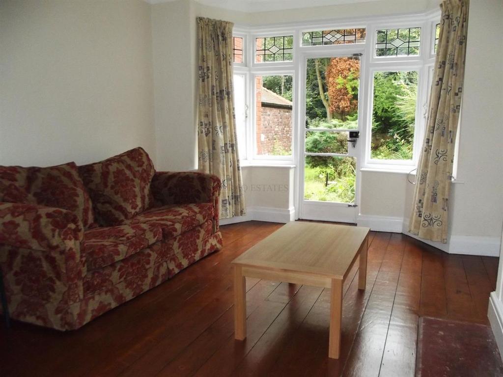 Bright living room with large windows and a doo...