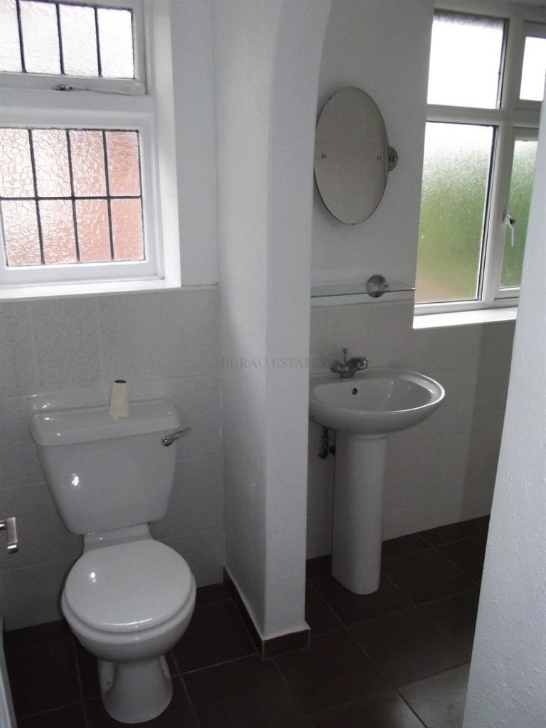 Bright, clean bathroom with white sanitaryware,...