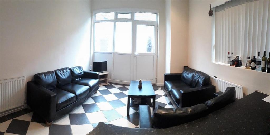 Bright living room with large front windows, bl...