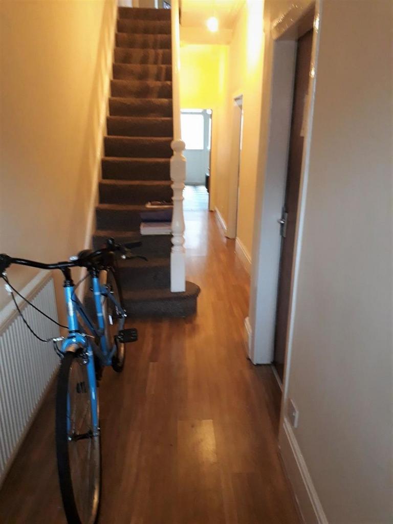Bright entrance hallway with wood-effect floori...