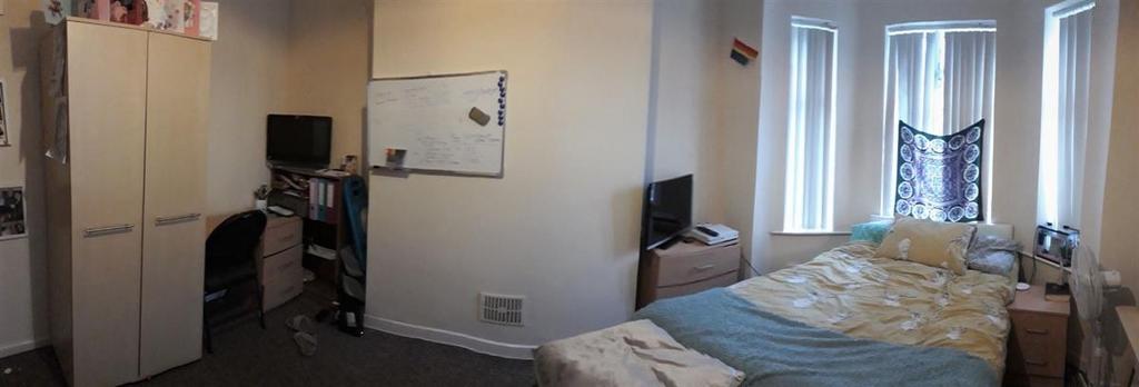 Bright and tidy double bedroom with a made bed,...