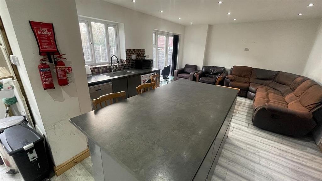 Spacious open-plan living area with a large cen...