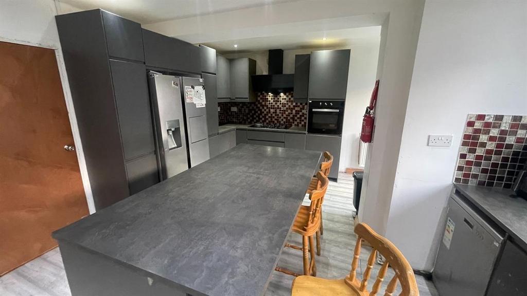 Modern kitchen with a long island countertop, i...