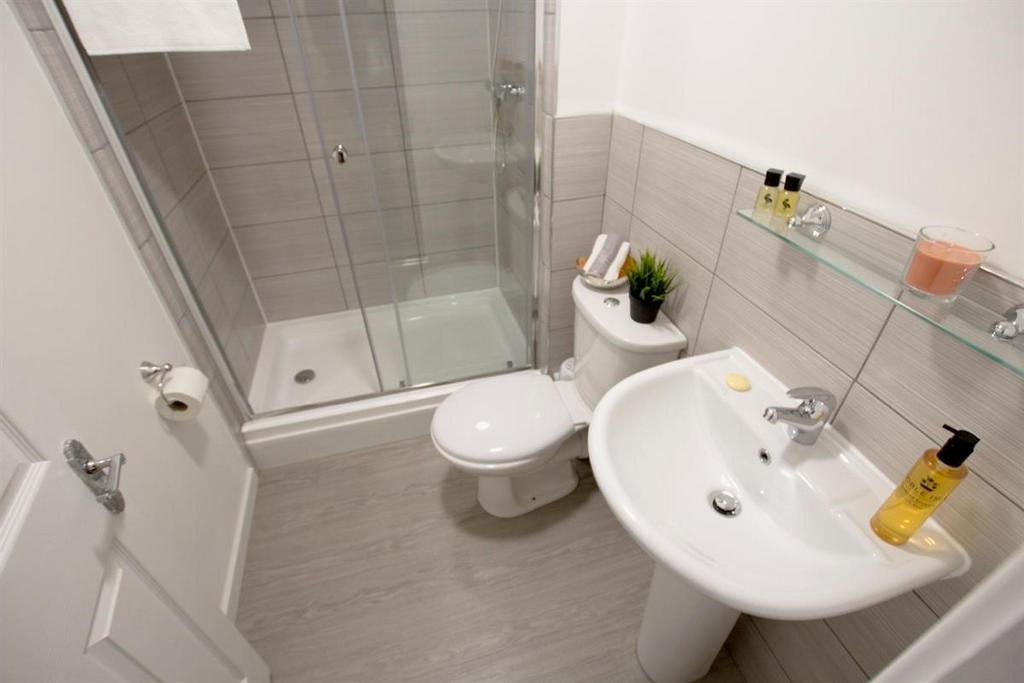 Modern private bathroom with a walk-in shower c...