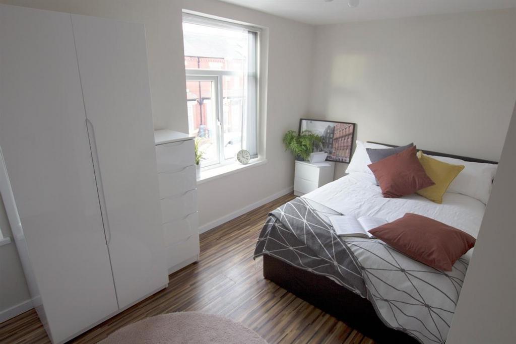 Bright, neatly presented bedroom with a comfort...